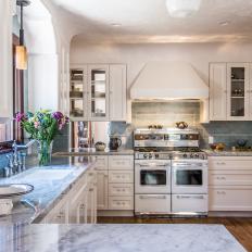 Traditional White Kitchen With Blue Tile Backsplash And Marble Countertop