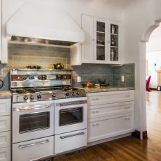 Traditional Historic White Kitchen With Blue Tile Backsplash And Marble Countertops