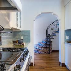 Traditional Spanish Colonial Kitchen With Blue Tile Backsplash And Arched Doorway