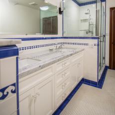 Traditional Historic White Bathroom With Blue Tile Accents And Marble Countertop