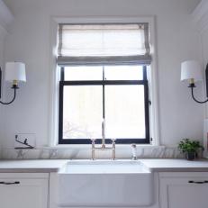 Farmhouse Sink Flanked By Chic Black Sconces