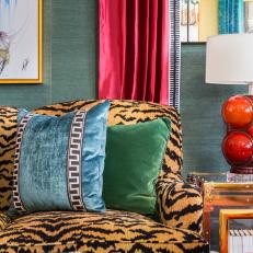 Modern Eclectic Living Room Detail With Tiger Print Loveseat And Colorful Curtains And Pillows