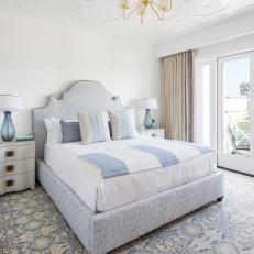 Modern White Cottage Master Bedroom With Upholstered Headboard And Blue Accessories