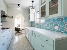 eclectic blue galley kitchen with bold backsplash