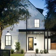 Modern White Farmhouse With Black Metal Accents And Covered Entry