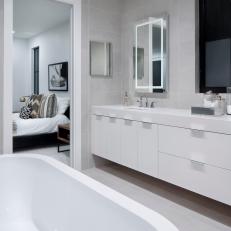 White And Gray Master Bathroom With Modern White Vanity And Tub