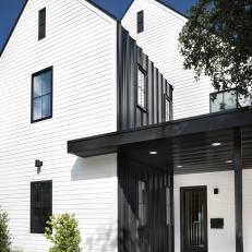 Modern White Farmhouse Covered Entry With Black Metal Panel Accent Wall 