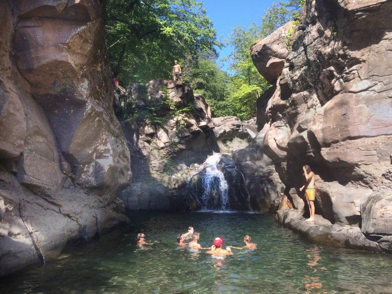 Some cast members enjoying the water while others wait to jump in Hunter, New York as seen on Travel Channel's Top Secret Swimming Holes episode TUSH201H.