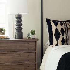 Modern Bedroom Detail With Black And White Accents And Contemporary Bedside Lamp