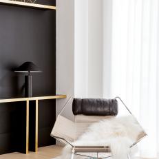 Modern Living Room Sitting Area With Black Accent Wall And Midcentury Modern Chair