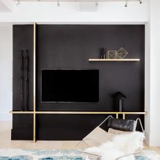 Modern Living Room Detail With Black Accent Wall And Floating Shelves And Task Lighting