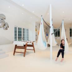 Tree With Hanging Chairs Offers Fun Seating in Playroom