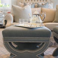 Traditional Master Bedroom Detail With Gray Upholstered Stool and Silver Tea Set