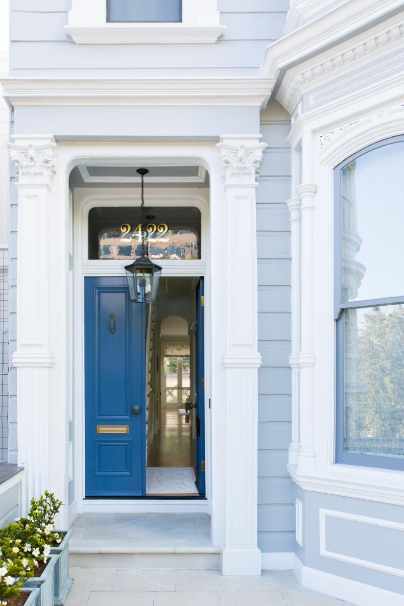 Classic Entrance With Blue Wood Doors And Pendant Lights