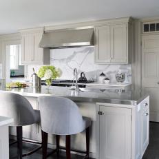 Contemporary White And Neutral Kitchen With Island And Bar Seating