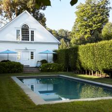 Traditional White Country Colonial Pool House With Saltwater Pool And Classic Landscape
