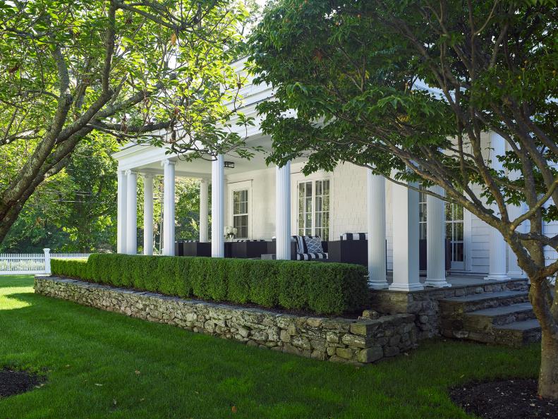 Classic White Porch With Columns And Outdoor Seating