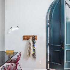 Eclectic Foyer With Arched Blue Door
