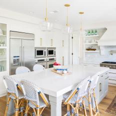 White Eat In Kitchen With Glass Front Cabinets And A Work Island With Seating And Storage