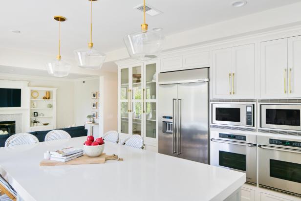Contemporary White Kitchen With Work Island And Modern Pendant