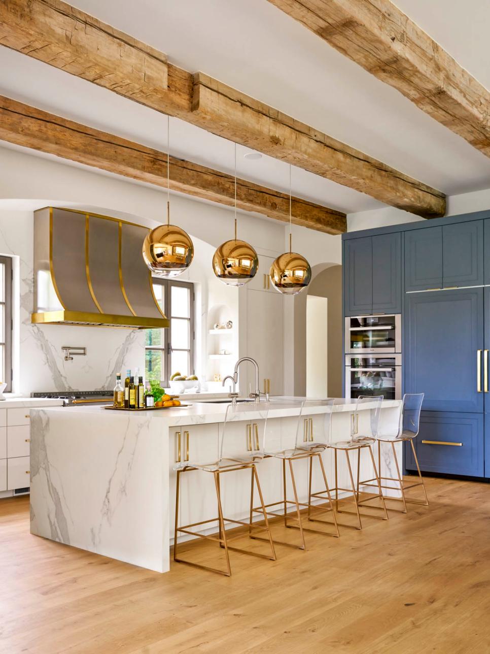 Bright Contemporary Kitchen Featuring Long Marble Island and Metallic