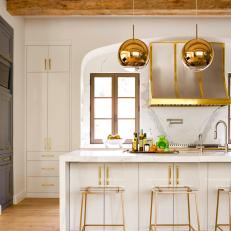 Metallic Gold Accents in Bright Contemporary Kitchen With Large Marble Island 