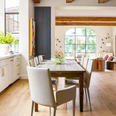Open Floor Dining Room With Simple Wood Table and Neutral Contemporary Chairs 