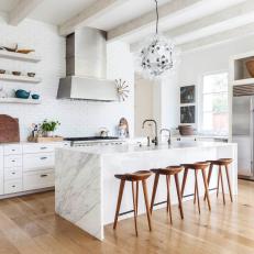 Bright Transitional Kitchen With White Marble Island, Bubble Light Fixture and Exposed Beams