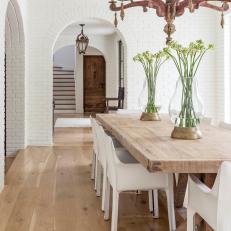 Bright, Transitional Dining Room Featuring Antique Chandelier and Natural Wood Dining Table