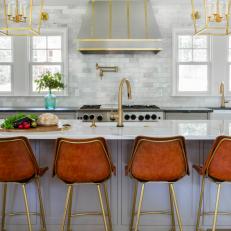 Light Transitional Kitchen With Red-Brown Bar Chairs and Brass Detail Accents 