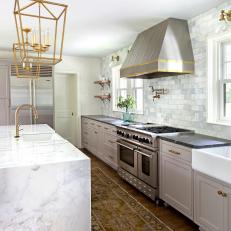 Gorgeous Transitional Kitchen With Waterfall Edge Marble Island, Brass Detailing and Marble Backsplash 