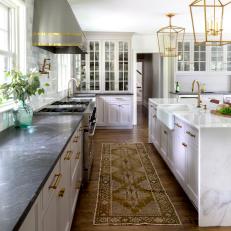 Transitional Kitchen With Black Marble Countertop, Brass Accents and Island Farmhouse Sink