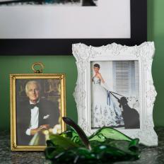 Whimsical Living Room Detail With Vintage Framed Photos And Green Glass Tray