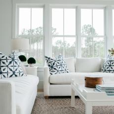 Modern White Cottage Living Room With Upholstered Sofas and Contemporary Coffee Table