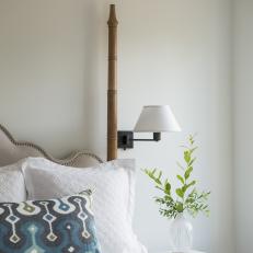 Traditional White Bedroom Detail With White Bedding And Upholstered Headboard