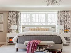 transitional master bedroom with patterned curtains