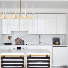 White Modern Kitchen With Brass Light Fixture