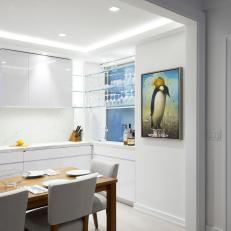 White Open Plan Kitchen With Penguin Art