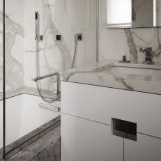 White Bathroom With Marbled Backsplash