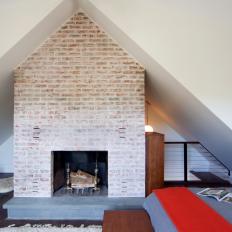 Contemporary Bedroom With Brick Fireplace