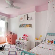 Pink Girl's Bedroom With Rainbow Rug