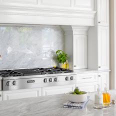 White Chef Kitchen Cooktop With Marble Backsplash