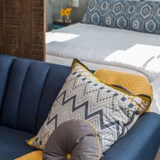 Blue Sofa With Yellow Throw