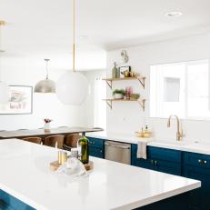 Blue and White Open Plan Kitchen With Globe Pendants