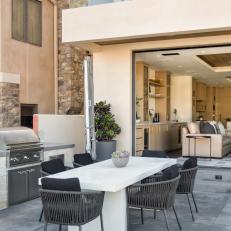 Patio With White Dining Table and Grill