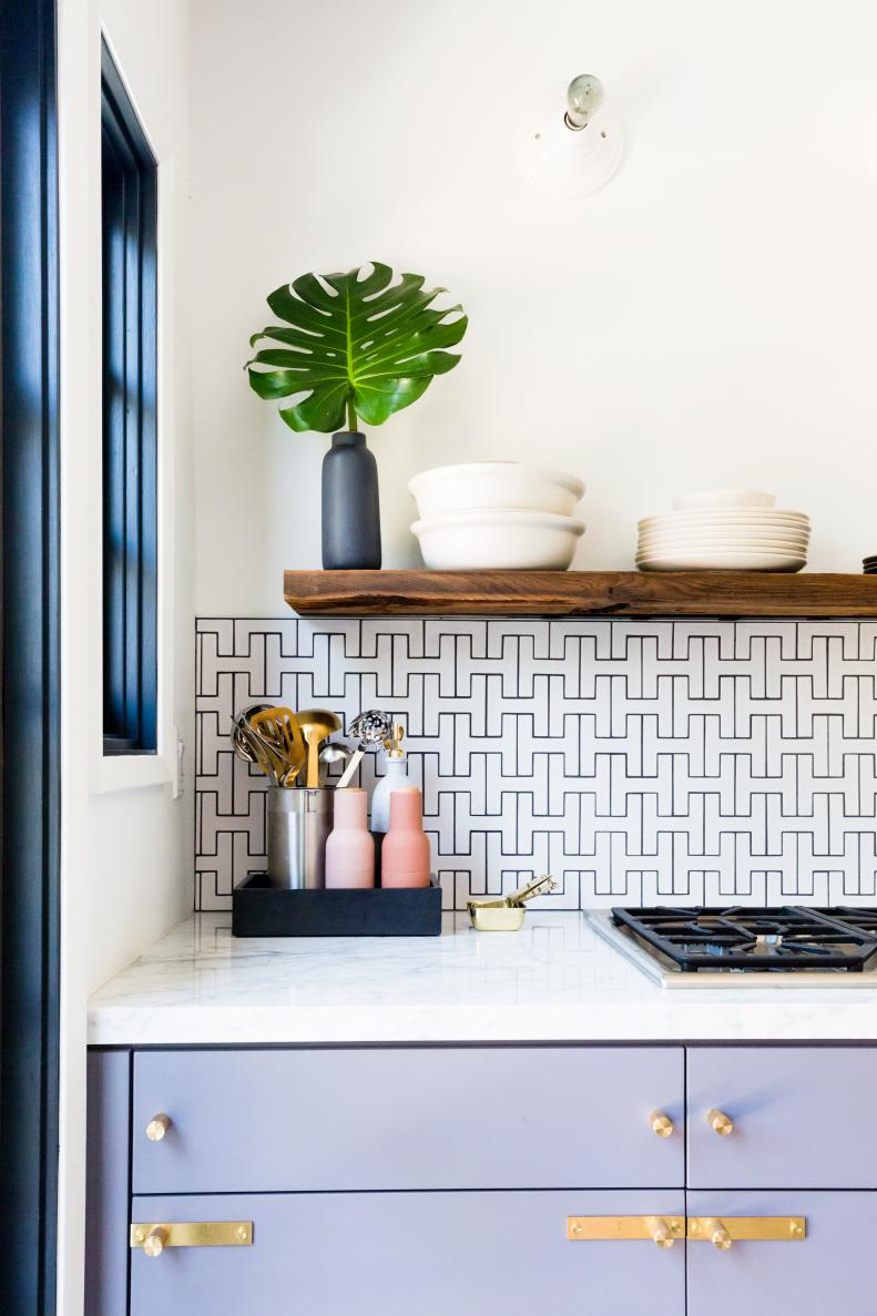 Custom colored cabinets with floating shelves create a unique kitchen. 