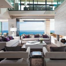 Modern Living Room With Gray Upholstered Seating And Gas Fireplace With Tile And Ocean Views