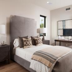 Contemporary Guest Bedroom With Gray Upholstered Bed And Headboard And Modern Accessories