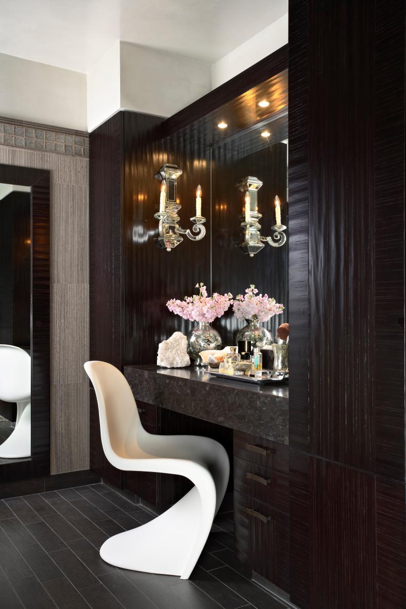 A beautiful espresso surround that encompasses a stunning vanity area.