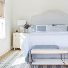 Blue and White Coastal Bedroom With Striped Rug